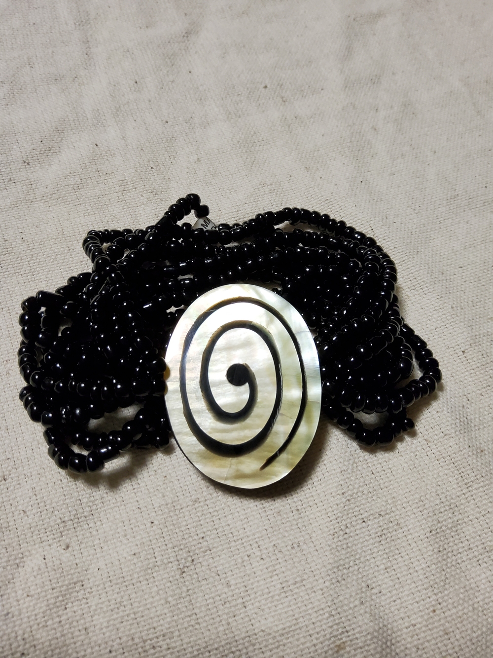 Beaded Multi-Strand Stretchy Bracelet with Coastal Mother-of-Pearl Spiral Accent